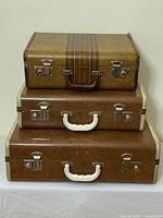 Stacked view showing three Langmuir Miralite luggage pieces, highlighting different sizes and materials