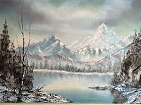 Close-up photo showing detail of the mountain landscape painting with signature visible.