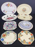 Overview image of eight serving platters and covered dish including floral and geometric patterns