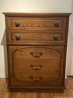 Full front view of the wooden highboy dresser showing all four drawers and top surface.