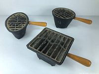 Three vintage Nasco miniature hibachi grills, different shapes (round, oval, square) with wooden handles.