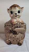 Front view of vintage Royal Sealy lamb cookie jar showing full body, facial details, and 'COOKIES' text on front.
