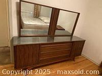 Full view of dresser and matching mirror showing overall condition