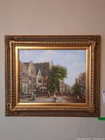 Full view of the framed canvas print showing a street scene with buildings, trees, and people