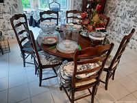 Seven chairs around dining table showing cushions and placemats