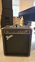 Front view of Fender Frontman 25B amplifier showing control panel and Fender logo