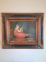 Full frontal image showing the entire framed print on a wall.