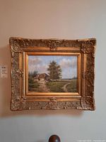 Full front view of the gilt-framed oil painting showing pastoral landscape scene
