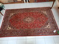 Top-down view of full rug on tile floor