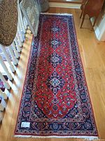 Full top-down view of the entire rug on hardwood floor showing overall pattern and shape