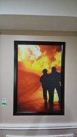 Front view of framed firefighter photo print showing two firefighters and fire flames
