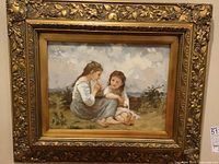 Full view of framed print showing two girls in landscape