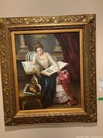 Full view of framed print showing seated woman with book and bread on table