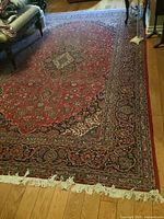 Full view of red Persian-style rug in room