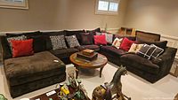 Angled front view of entire four-piece sectional with matching brown cushions and decorative pillows.