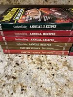 Stack of Southern Living Annual Recipes cookbooks from years 1986 to 1993 showing spines with title and year details.
