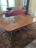 Full top view of the wooden dining table showing natural wood finish and extension seam.