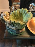 Ceramic dish with perching birds and leaf design, mostly green and earthy tones