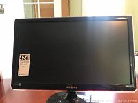 Front view of the Samsung computer monitor showing the screen and stand with a visible label.