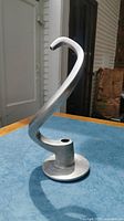 Metal dough hook attachment displayed upright showing full shape and curved hook design.