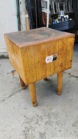 Full view of maple butcher block cube on four legs