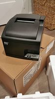 Star SP700 thermal receipt printer placed on its original box, showing the full unit with curved top.