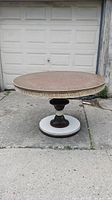 Full view of vintage round pedestal table showing tabletop and base
