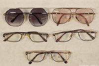 Top view of all 5 glasses showing 2 sunglasses with tinted lenses and 3 prescription glasses.