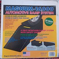 Box front showing Magnum-16000 Automotive Ramp System branding with product features in English, Spanish, and French; 4 piece detachable ramp system with safety chock, 16,000 lb vehicle capacity, eco-friendly materials.