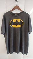 Front view of the dark gray Batman T-shirt with yellow Batman logo.