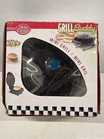 Box showing front of Betty Crocker Grill Buddy Mini Grill packaging with product visible through plastic window.