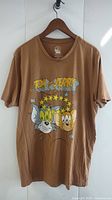Front view of brown Tom and Jerry XL T-shirt on hanger showing full shirt and graphic.