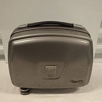 Closed view of vintage Bolex Paillard film projector in a gray metal case with handle and Bolex logo.