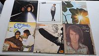 Photo of six vinyl record album covers including Gino Vannelli, Led Zeppelin, Neil Diamond, Joe Cocker, Crosby, Stills & Nash, and Billy Joel.