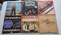 Photo showing six vinyl record albums including Elton John, Shanana, The Rolling Stones, The Temptations (two copies), The Beatles VI, and Neil Young's Harvest.