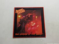 Front cover of April Wine's The Nature of the Beast LP showing the band name and album title with a performing band member on stage in red lighting.