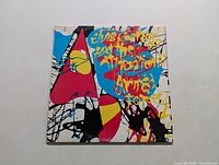 Front cover of 'Armed Forces' album by Elvis Costello with colorful abstract design and yellow text.