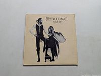 Front cover of Fleetwood Mac Rumours LP with artistic photo of two band members and album title.