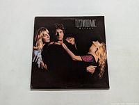Front cover of Fleetwood Mac Mirage vinyl LP album with image of three band members.