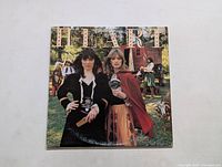 Front cover of Heart Little Queen LP album showing two women in period costumes outdoors.