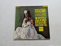 Front album cover showing a woman covered in whipped cream with text of band and album name.