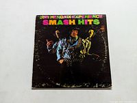 Front album cover of the Jimi Hendrix Experience Smash Hits LP showing colorful band photo and rainbow text on black background.
