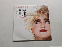 Front cover of Madonna's "Who's That Girl" original motion picture soundtrack LP showing Madonna's face and title text.