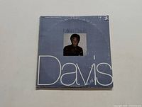 Front cover of Miles Davis LP showing light blue background with portrait photo of Miles Davis and large 'Davis' text.