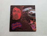 Front cover of Red Rose Speedway LP by Paul McCartney & Wings showing Paul McCartney's portrait with a red rose.