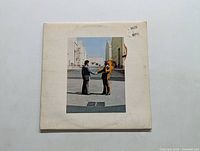 Front cover of Pink Floyd Wish You Were Here vinyl LP, showing two men shaking hands, one man on fire.