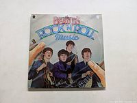 Front cover of The Beatles Rock 'n' Roll Music LP showing illustrated Beatles members and title