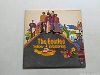 Front cover of The Beatles Yellow Submarine LP showing colorful illustrated band members and yellow submarine.