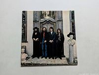 Front cover of The Beatles "Hey Jude" LP showing the band in front of a stone doorway.