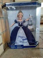 Front view of Millennium Princess Barbie doll in original packaging showing doll dressed in dark blue gown with silver details and accessories.